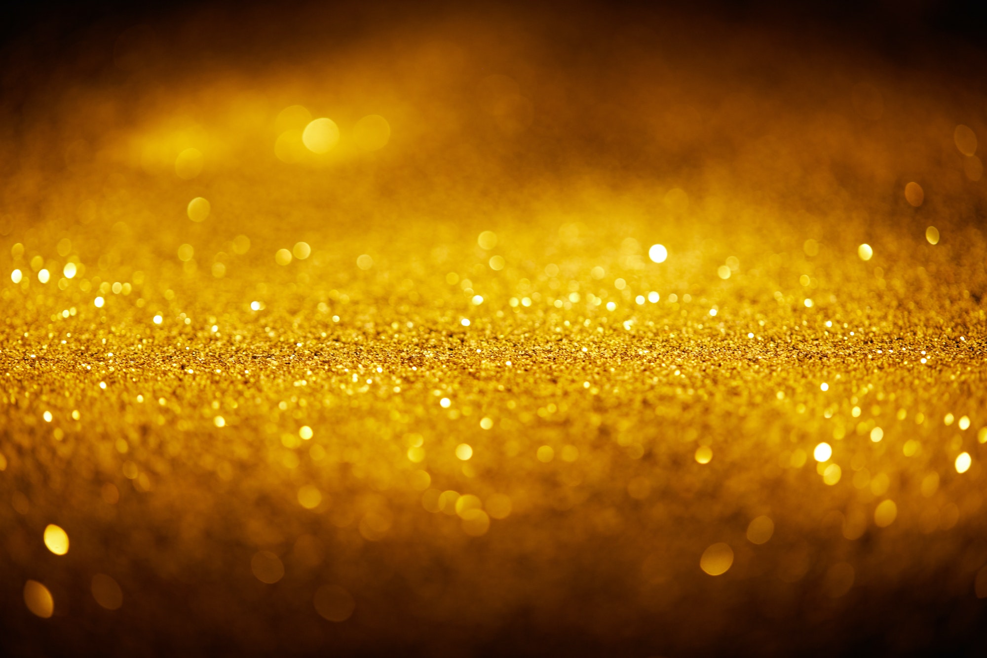 abstract shiny gold glitter on dark background